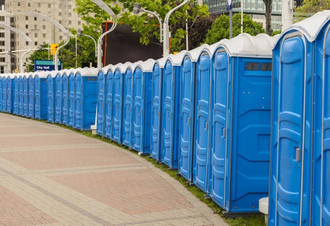 a row of portable restrooms set up for a large athletic event, allowing participants and spectators to easily take care of their needs in Alpharetta GA